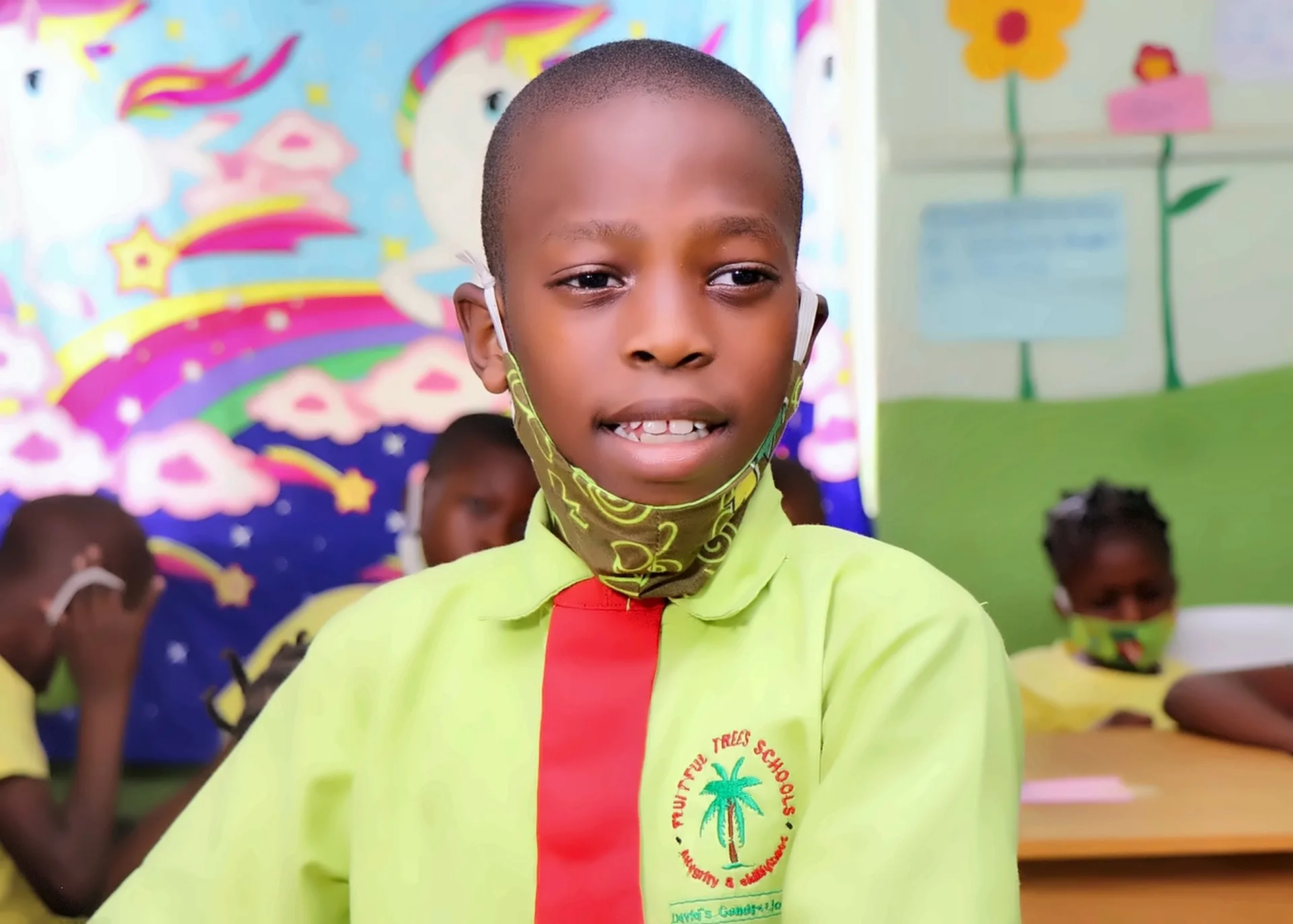A Fruitful Trees pupil in school uniform smiling in a classroom.